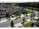 Street view of houses on a sunny day, surrounded by green grass and manicured trees at 7955 Delwin Ln, Reunion, FL 34747
