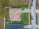 Aerial view of home featuring a brown shingle roof, a well-manicured lawn and ample parking in the driveway at 847 Cumberland Cir, Minneola, FL 34715