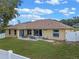 Aerial view of the backyard, featuring a patio, well-maintained lawn, and fenced perimeter at 847 Cumberland Cir, Minneola, FL 34715