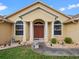 Close-up of the front entrance showcasing a double-door entry with decorative columns and landscape details at 847 Cumberland Cir, Minneola, FL 34715