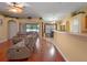 Bright living room with wood floors opens to breakfast nook and features slider to outdoor living at 847 Cumberland Cir, Minneola, FL 34715