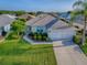 Aerial view of a lovely home with manicured lawn, mature landscaping, and two car garage at 8601 Se 133Rd St, Summerfield, FL 34491