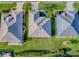 Aerial view of the home's roof, lawn, and adjacent homes and manicured landscaping at 8601 Se 133Rd St, Summerfield, FL 34491