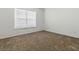 Neutral carpeted bedroom with a bright window and white walls at 8601 Se 133Rd St, Summerfield, FL 34491