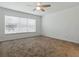 Bedroom with carpet and a light-filled window at 8601 Se 133Rd St, Summerfield, FL 34491