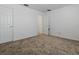 Neutral carpeted bedroom featuring white walls and doors at 8601 Se 133Rd St, Summerfield, FL 34491