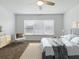 Well-decorated bedroom with plush carpet, a bed, a chair, a dresser, and a large window at 8601 Se 133Rd St, Summerfield, FL 34491