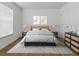 Bedroom with bed, bedside tables, and bright window at 8601 Se 133Rd St, Summerfield, FL 34491