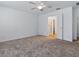 Spacious bedroom featuring plush carpet, ceiling fan, and access to an en-suite bathroom at 8601 Se 133Rd St, Summerfield, FL 34491