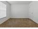 Neutral carpeted bedroom with white walls, a window, and a door at 8601 Se 133Rd St, Summerfield, FL 34491