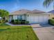 Charming one-story home featuring manicured landscaping and an attached two-car garage at 8601 Se 133Rd St, Summerfield, FL 34491