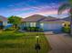 Charming single story home showcasing manicured landscaping, lush green lawn and an attached two car garage at 8601 Se 133Rd St, Summerfield, FL 34491