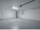 Spacious two car garage with white painted walls and sealed concrete floors at 8601 Se 133Rd St, Summerfield, FL 34491