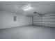 Spacious two car garage with white painted walls and sealed concrete floors at 8601 Se 133Rd St, Summerfield, FL 34491
