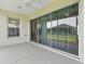 Spacious lanai with sliding glass doors and view of the backyard at 8601 Se 133Rd St, Summerfield, FL 34491