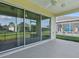 Enclosed lanai with sliding glass doors offering views of the backyard and seating area at 8601 Se 133Rd St, Summerfield, FL 34491
