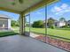 Screened-in lanai offers views of the manicured backyard and lush landscaping at 8601 Se 133Rd St, Summerfield, FL 34491