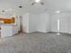 Open living area showing neutral carpet, a modern front door, and a kitchen bar, perfect for gatherings at 8601 Se 133Rd St, Summerfield, FL 34491