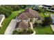Stunning aerial view of a two-story home with a tile roof, lush landscaping, and a paved driveway at 8719 Kenmure Cv, Orlando, FL 32836