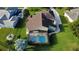 Aerial view of the backyard featuring a screened pool area, a fenced yard, and pristine landscaping at 8719 Kenmure Cv, Orlando, FL 32836