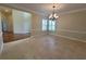 Formal dining room with elegant chandelier, crown molding, and ample space for entertaining at 8719 Kenmure Cv, Orlando, FL 32836