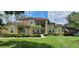 Stunning two-story home with a well-manicured lawn, lush landscaping, and beautiful curb appeal at 8719 Kenmure Cv, Orlando, FL 32836