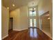 Grand foyer with soaring ceilings, hardwood floors, and a stunning chandelier at 8719 Kenmure Cv, Orlando, FL 32836