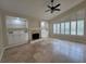 Bright living room with built-in shelves, a fireplace, plantation shutters, and tile flooring at 8719 Kenmure Cv, Orlando, FL 32836