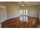 Spacious bedroom with hardwood floors, ceiling fan, and private access to the outdoors at 8719 Kenmure Cv, Orlando, FL 32836