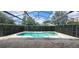 Enjoy the outdoors in this screened-in pool area, perfect for relaxation and entertainment at 8719 Kenmure Cv, Orlando, FL 32836