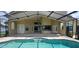 Relax in this pool area featuring a covered patio and clear views of the refreshing blue pool at 8719 Kenmure Cv, Orlando, FL 32836