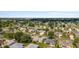 Expansive aerial view of a well-maintained neighborhood with mature trees, lush greenery, and attractive single-Gathering homes at 965 Eastmont Ct, The Villages, FL 32162