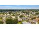 Panoramic aerial view showcasing a peaceful suburban neighborhood featuring neatly arranged homes and verdant landscaping at 965 Eastmont Ct, The Villages, FL 32162