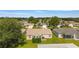 Aerial view of backyard with a cozy patio and well-maintained lawn at 965 Eastmont Ct, The Villages, FL 32162