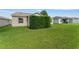 View of the backyard with a healthy lawn and neat shrubbery at 965 Eastmont Ct, The Villages, FL 32162