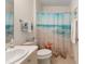Charming bathroom featuring a beach-themed shower curtain and neutral tile flooring at 965 Eastmont Ct, The Villages, FL 32162