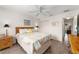 Bright bedroom with a ceiling fan and view into hallway with closet and door at 965 Eastmont Ct, The Villages, FL 32162