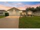 Charming single-story home with a well-manicured lawn and an attached two-car garage at 965 Eastmont Ct, The Villages, FL 32162