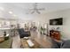 Open-concept living and dining area with wood floors and modern decor at 965 Eastmont Ct, The Villages, FL 32162