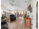 Open-concept living room with wood floors and a seamless view into the modern kitchen and dining area at 965 Eastmont Ct, The Villages, FL 32162