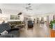 Open-concept living room with wood floors and a seamless view into the modern kitchen and dining area at 965 Eastmont Ct, The Villages, FL 32162