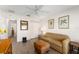 Cozy living room with a neutral-toned sofa and matching ottoman at 965 Eastmont Ct, The Villages, FL 32162