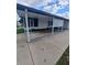 View of the covered back patio featuring white columns, a white door, and a lattice privacy screen at 1005 Matthew Ave, Lady Lake, FL 32159