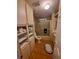 Bathroom featuring a shower with glass doors, built in storage and a neutral color palette at 1005 Matthew Ave, Lady Lake, FL 32159