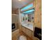 Traditional bathroom featuring a vanity, shower and tub combo and decorative wallpaper at 1005 Matthew Ave, Lady Lake, FL 32159