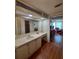 Bathroom includes vanity, mirror, and view of bedroom and closet at 1005 Matthew Ave, Lady Lake, FL 32159