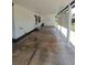 Exterior view of home with concrete carport, white columns and door with small staircase at 1005 Matthew Ave, Lady Lake, FL 32159
