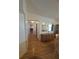 Hallway with hardwood floors, neutral wall color, white trim, and views of other rooms at 1005 Matthew Ave, Lady Lake, FL 32159