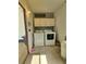 Laundry room with a side-by-side washer and dryer and cabinet storage above at 1005 Matthew Ave, Lady Lake, FL 32159