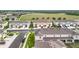 Aerial view of a residential area with townhomes, landscaped streets, and community amenities at 1042 Lido Dr, Howey In The Hills, FL 34737